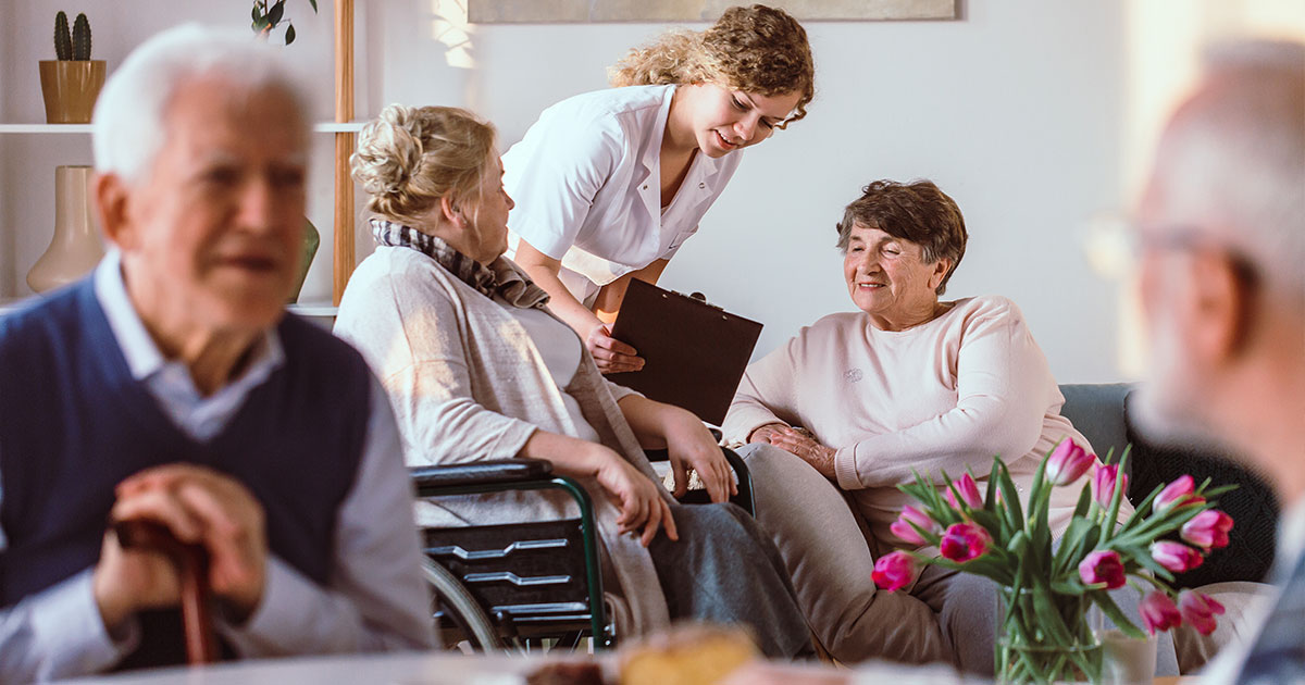 Nurse helping senior residents with medication at a long-term care facility, representing Clarity LTC’s focus on efficiency and transparent pricing.